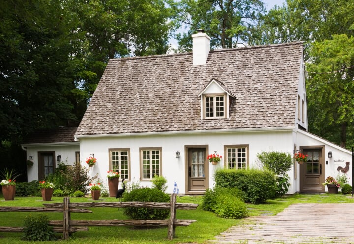 White Cottage With Dormer Windows and Flower Boxes at Independent Living Facility